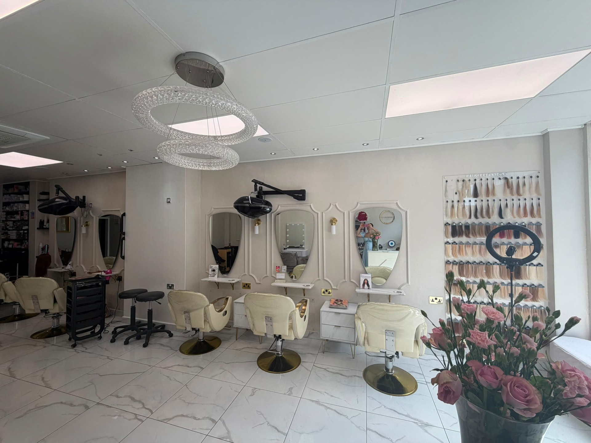 Art In London salon floor with styling stations and hair extension colour ring
